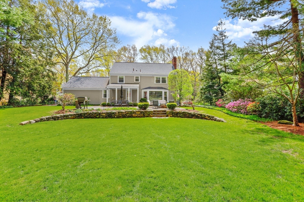 109 Suffolk Road Wellesley, MA 02481 - Photo 24 of 24 a front view of a house with a yard table and chairs