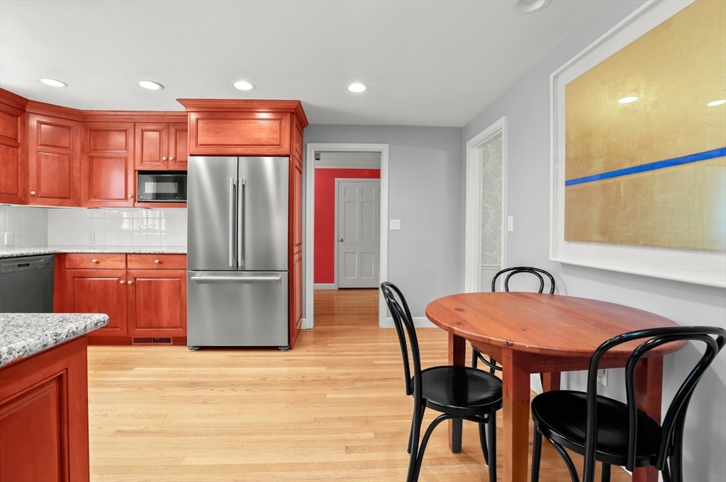 109 Suffolk Road Wellesley, MA 02481 - Photo 5 of 24 a kitchen with stainless steel appliances a dining table chairs and refrigerator
