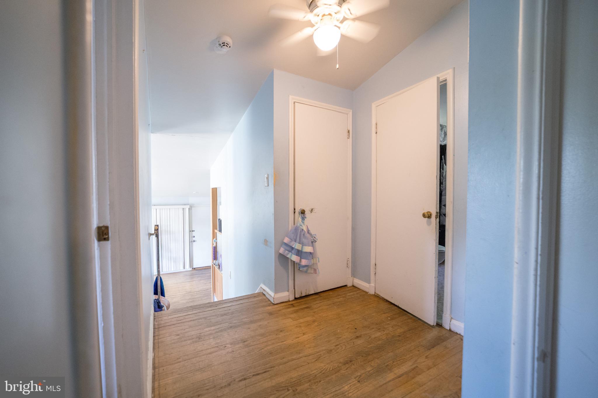 4125 Ronis Road Pikesville, MD 21208 - Photo 4 of 40 a view of an empty room with wooden floor and a bathroom