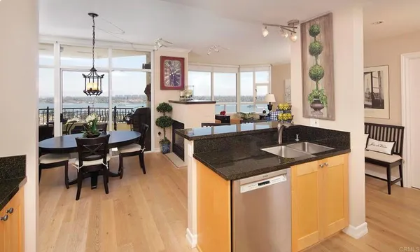 a kitchen with a table chairs sink and cabinets