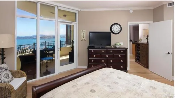 a bedroom with a bed and a television