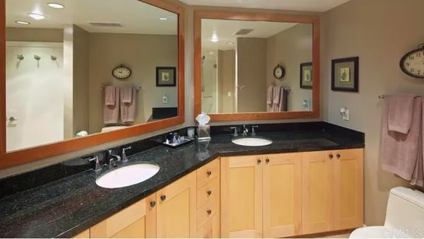 a bathroom with a granite countertop sink and a mirror