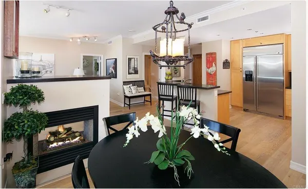 a living room with fireplace furniture dining table and a fireplace