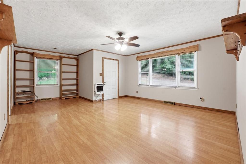 399 Donahoo Road Southeast Silver Creek, GA 30173 - Photo 4 of 22 an empty room with wooden floor and windows