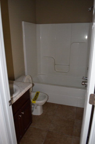 485 Bob White Road Macon, GA 31216 - Photo 4 of 13 a bathroom with a granite countertop toilet and sink