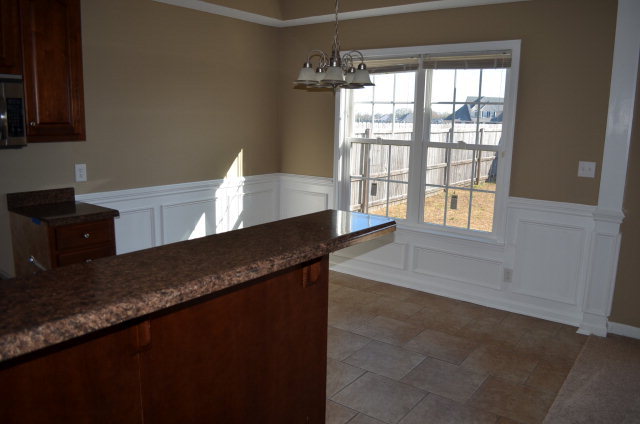 485 Bob White Road Macon, GA 31216 - Photo 8 of 13 a view of a kitchen with granite countertop cabinets a sink and a window