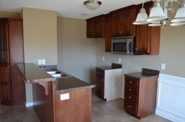485 Bob White Road Macon, GA 31216 - Photo 9 of 13 a kitchen with stainless steel appliances granite countertop a stove microwave and sink