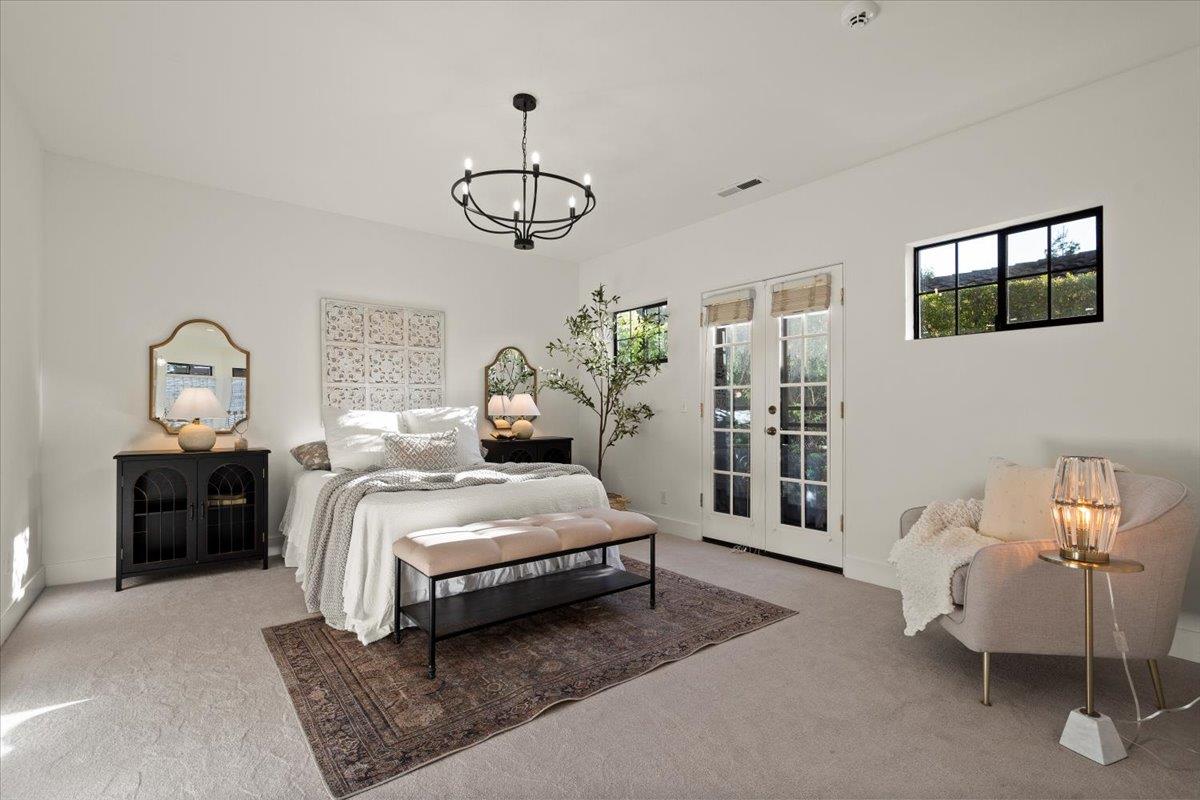 731 5th Street Gilroy, CA 95020 - Photo 15 of 31 a spacious bedroom with a bed and a chandelier