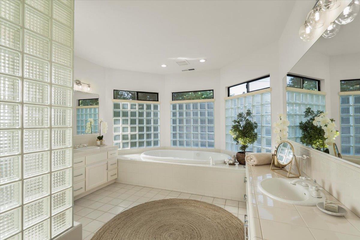 731 5th Street Gilroy, CA 95020 - Photo 18 of 31 a spacious bathroom with a tub a potted plant and a large window