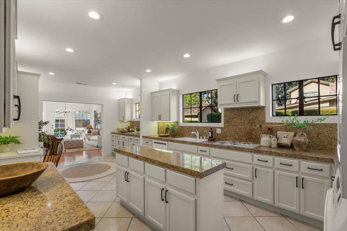 731 5th Street Gilroy, CA 95020 - Photo 6 of 31 a large kitchen with kitchen island a sink a stove a dining table and chairs