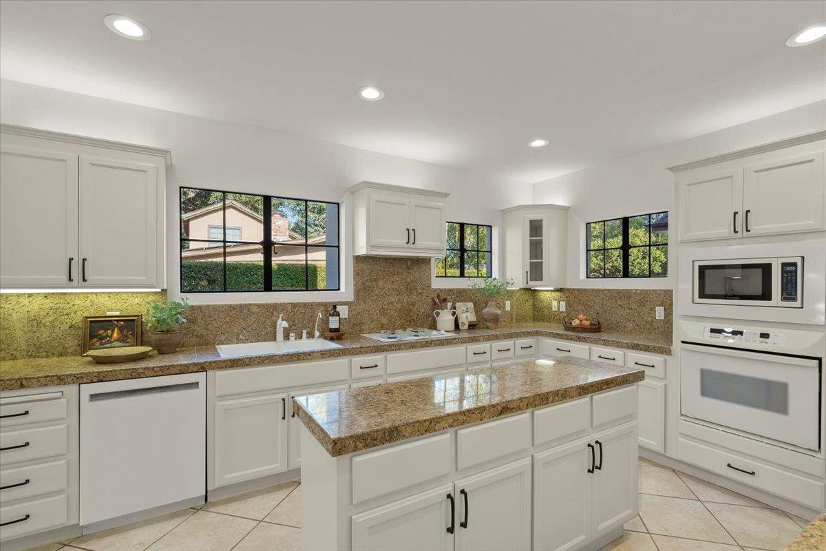 731 5th Street Gilroy, CA 95020 - Photo 8 of 31 a kitchen with granite countertop a sink and white cabinets