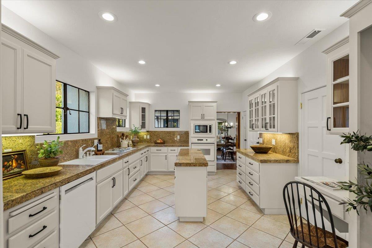 731 5th Street Gilroy, CA 95020 - Photo 9 of 31 a large white kitchen with lots of counter space and windows