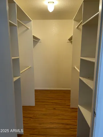 a view of a room with wooden floor and bathroom