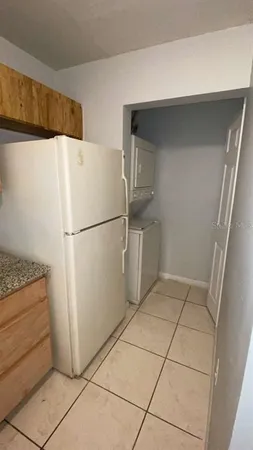 a white refrigerator freezer and a stove sitting inside of a kitchen