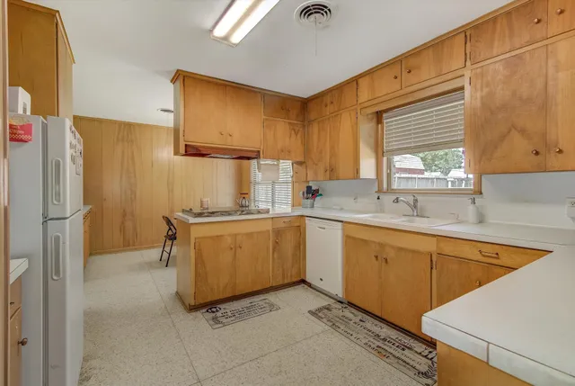 a kitchen with a sink cabinets and window