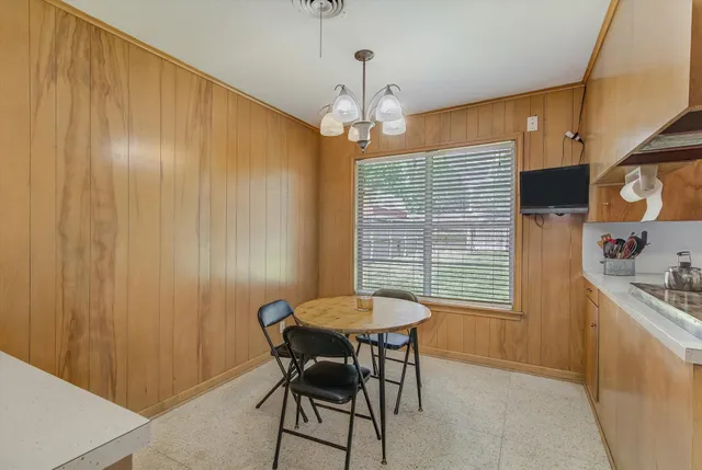 a dining room with furniture and window