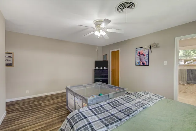 a bedroom with bed and a chandelier