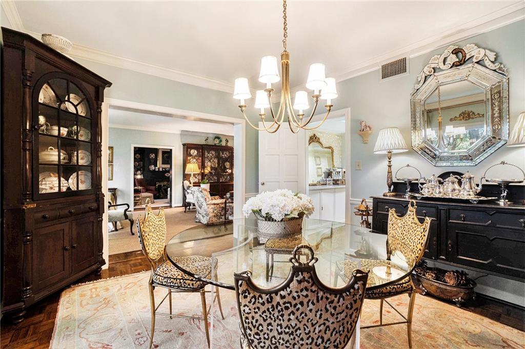 a view of a dining room with furniture and chandelier