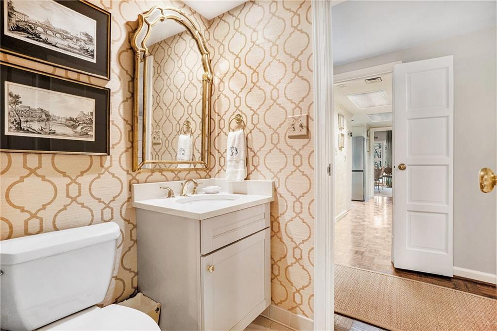 2769 Peachtree Road Northeast, Unit 6 Atlanta, GA 30305 - Photo 12 of 25 a bathroom with a sink a toilet and shower