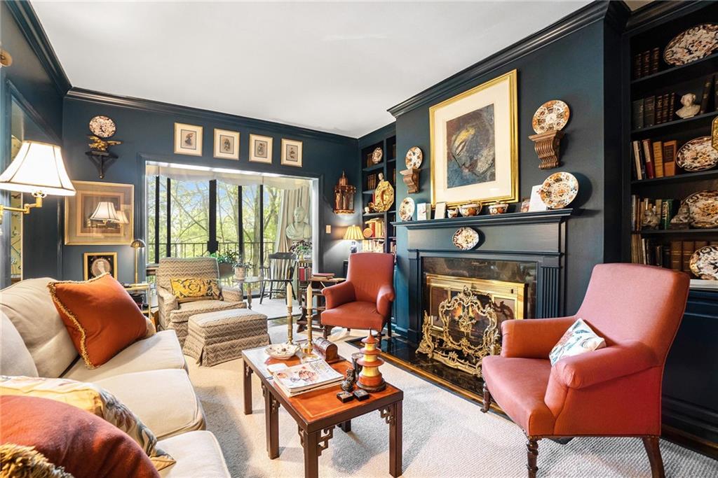2769 Peachtree Road Northeast, Unit 6 Atlanta, GA 30305 - Photo 5 of 25 a living room with furniture a fireplace and a large window