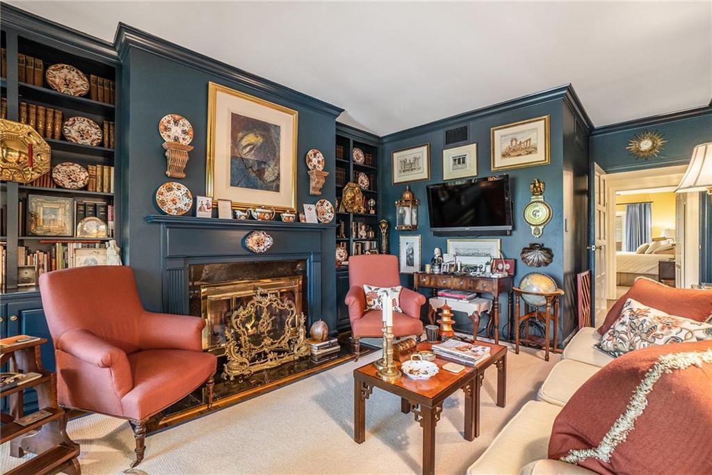 2769 Peachtree Road Northeast, Unit 6 Atlanta, GA 30305 - Photo 6 of 25 a living room with furniture a fireplace and a flat screen tv