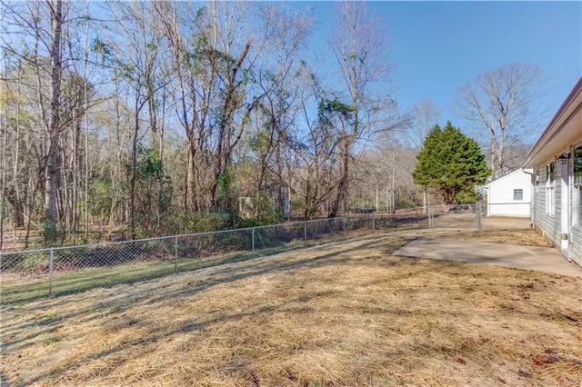a view of a backyard with large trees