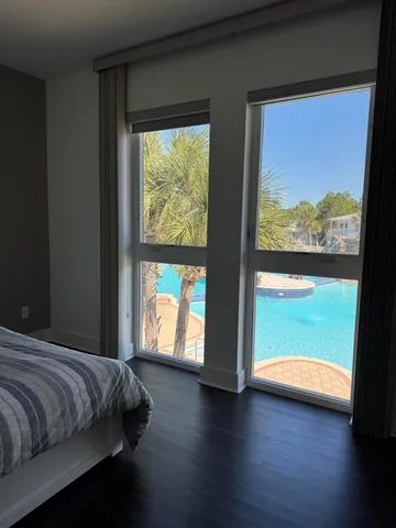 a bedroom with a bed and a large window