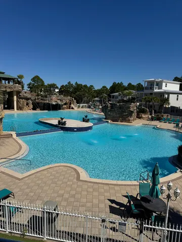 a view of a swimming pool and lounge chairs