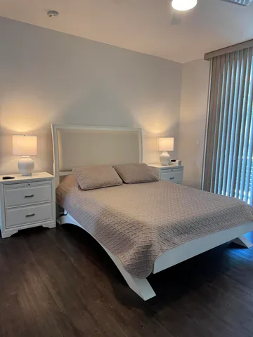 a bedroom with a bed and a night stand
