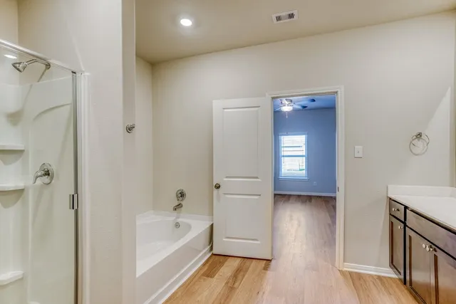 a bathroom with a bathtub and a shower