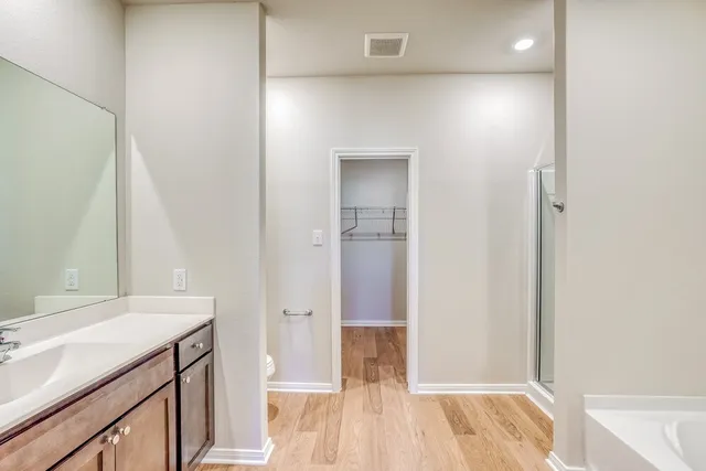 a spacious bathroom with a sink and a mirror
