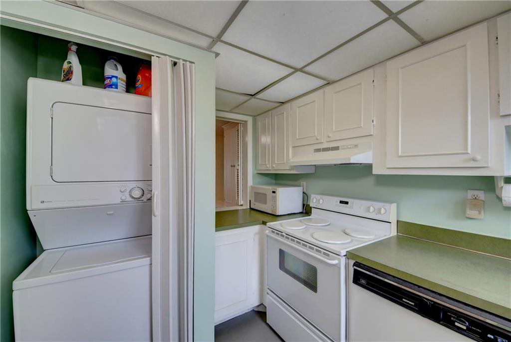 5111 Southeast Miles Grant Road, Unit 104 Stuart, FL 34997 - Photo 13 of 36 a utility room with dryer and washer