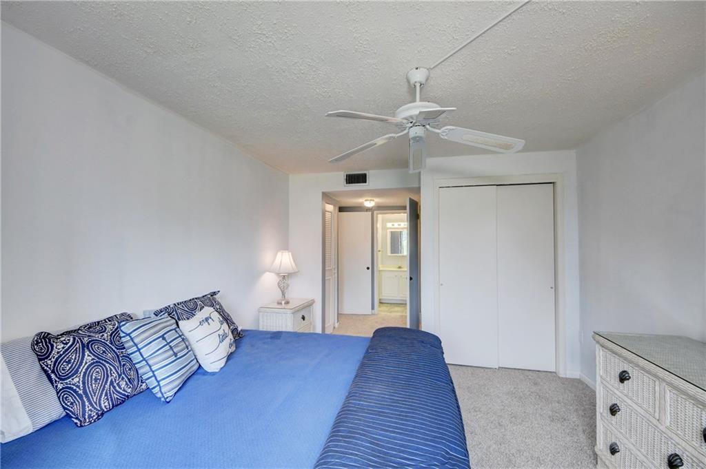 5111 Southeast Miles Grant Road, Unit 104 Stuart, FL 34997 - Photo 17 of 36 a bedroom with a bed and window