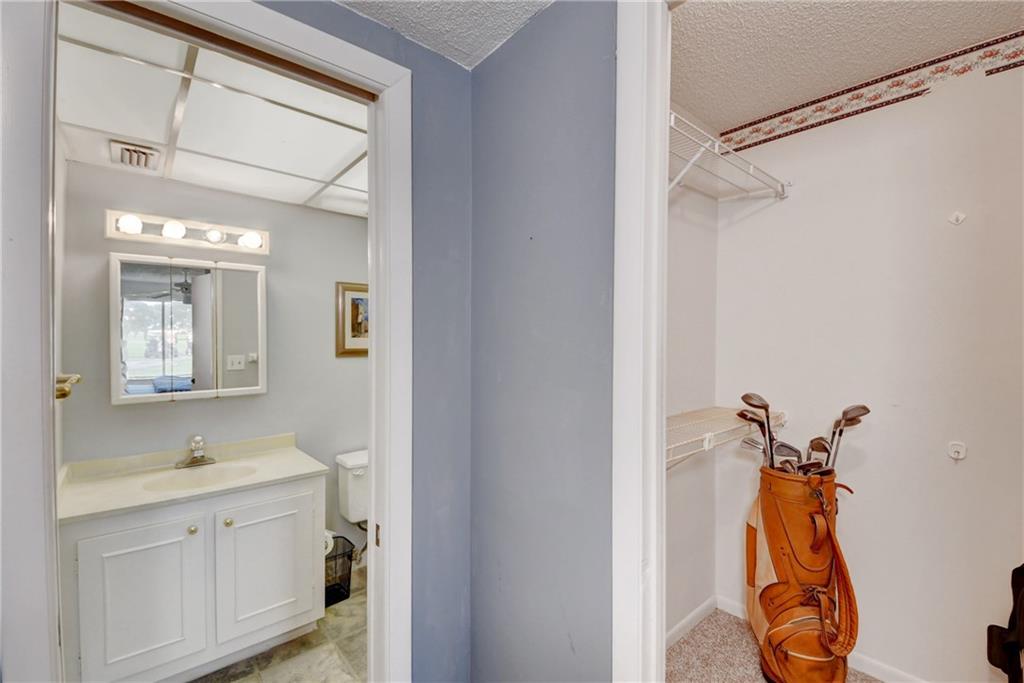 5111 Southeast Miles Grant Road, Unit 104 Stuart, FL 34997 - Photo 19 of 36 a bathroom with a sink mirror and a shower