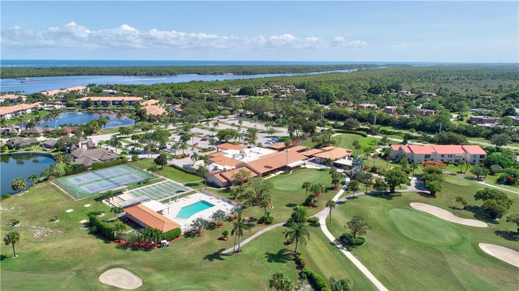 5111 Southeast Miles Grant Road, Unit 104 Stuart, FL 34997 - Photo 2 of 36 an aerial view of residential houses with outdoor space and lake view