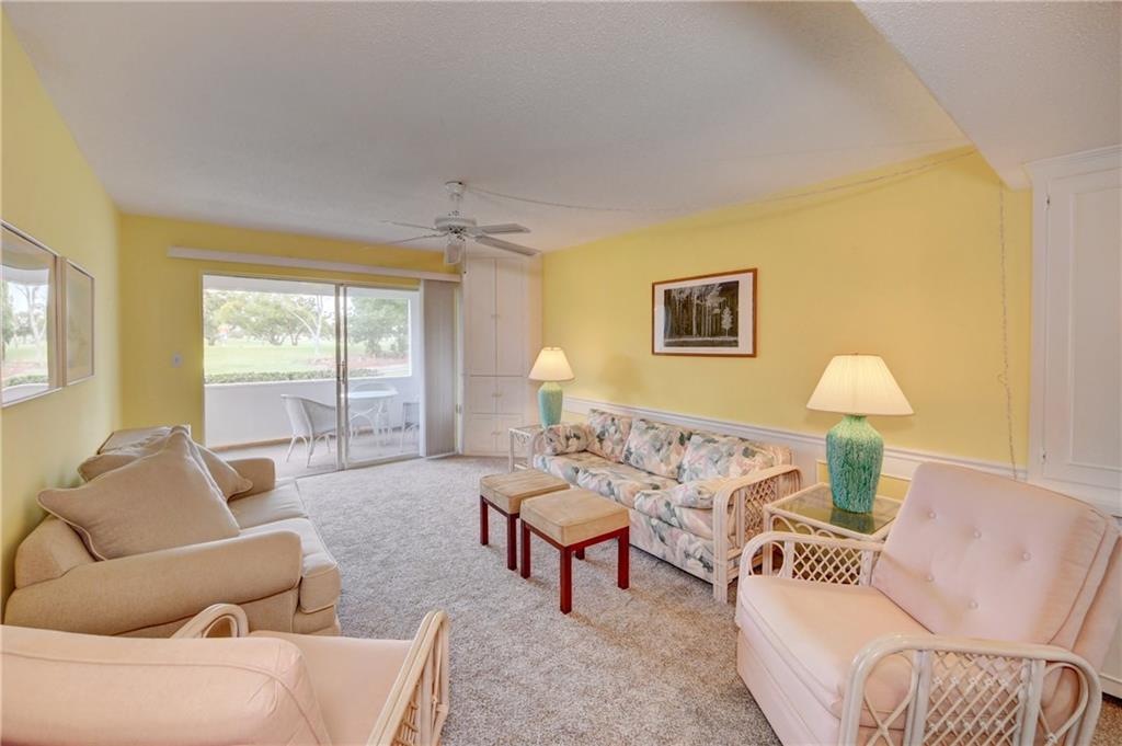 5111 Southeast Miles Grant Road, Unit 104 Stuart, FL 34997 - Photo 21 of 36 a living room with furniture and a window