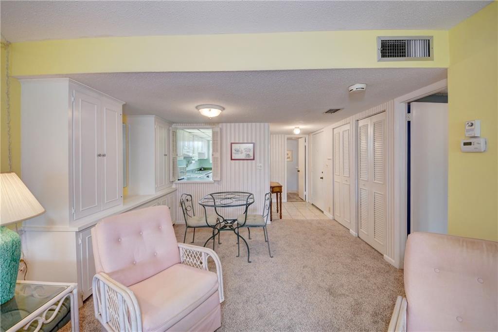 5111 Southeast Miles Grant Road, Unit 104 Stuart, FL 34997 - Photo 22 of 36 a dining room with furniture and a window