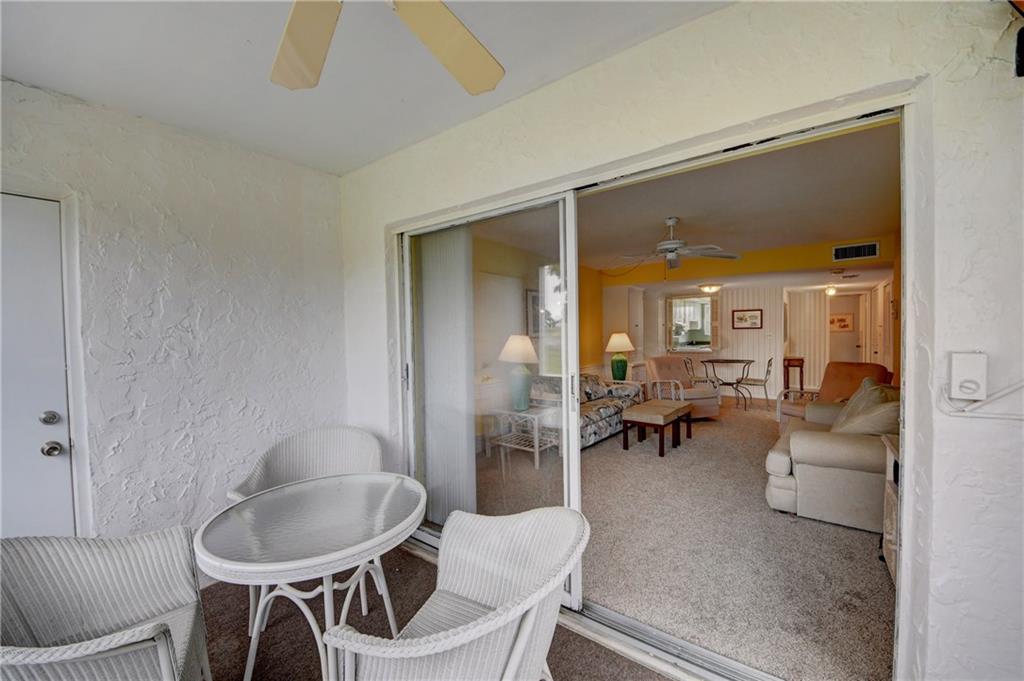5111 Southeast Miles Grant Road, Unit 104 Stuart, FL 34997 - Photo 26 of 36 a dining room with furniture and a potted plant