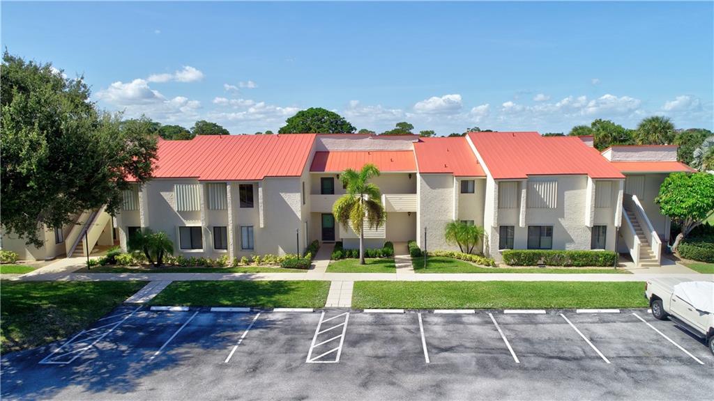 5111 Southeast Miles Grant Road, Unit 104 Stuart, FL 34997 - Photo 31 of 36 a view of a building with a yard