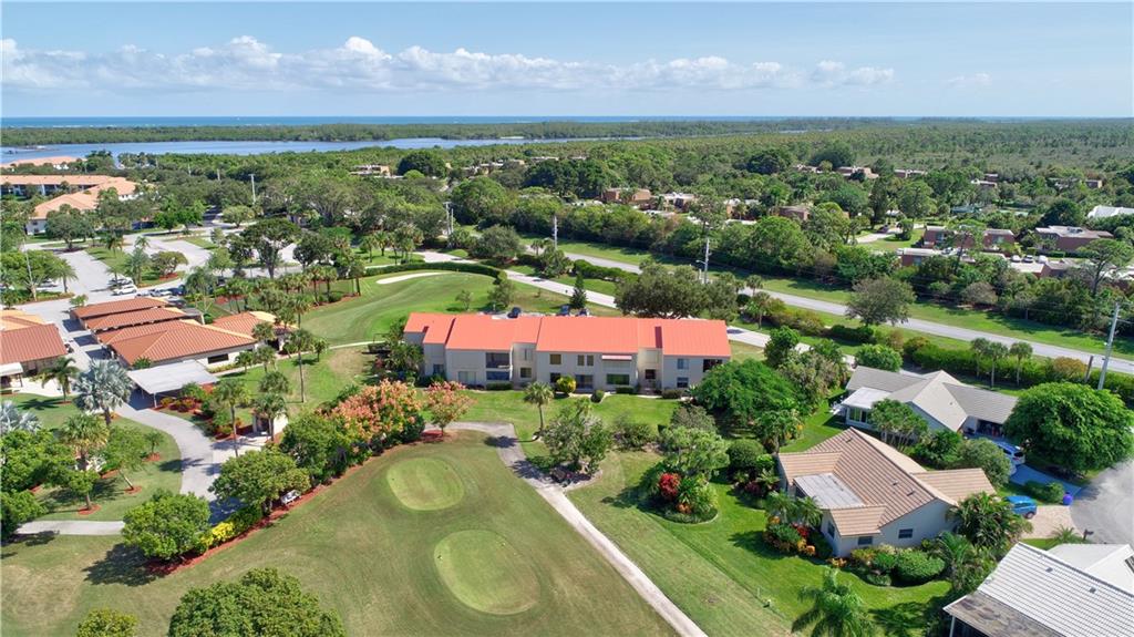 5111 Southeast Miles Grant Road, Unit 104 Stuart, FL 34997 - Photo 36 of 36 an aerial view of residential houses with outdoor space and pool