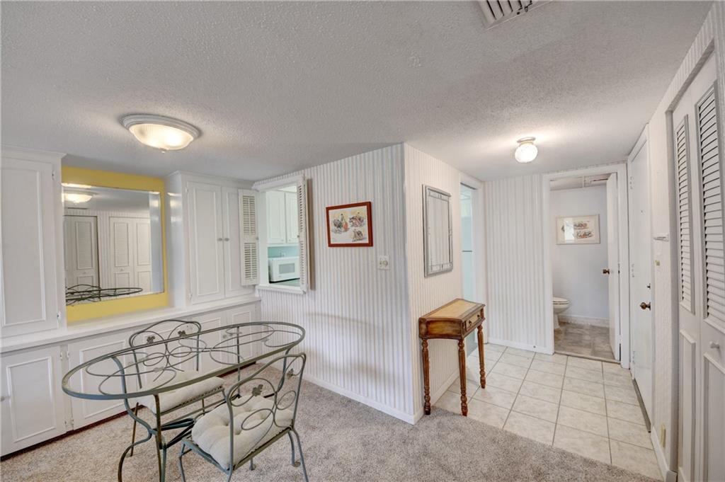 5111 Southeast Miles Grant Road, Unit 104 Stuart, FL 34997 - Photo 7 of 36 a view of a livingroom with furniture and staircase