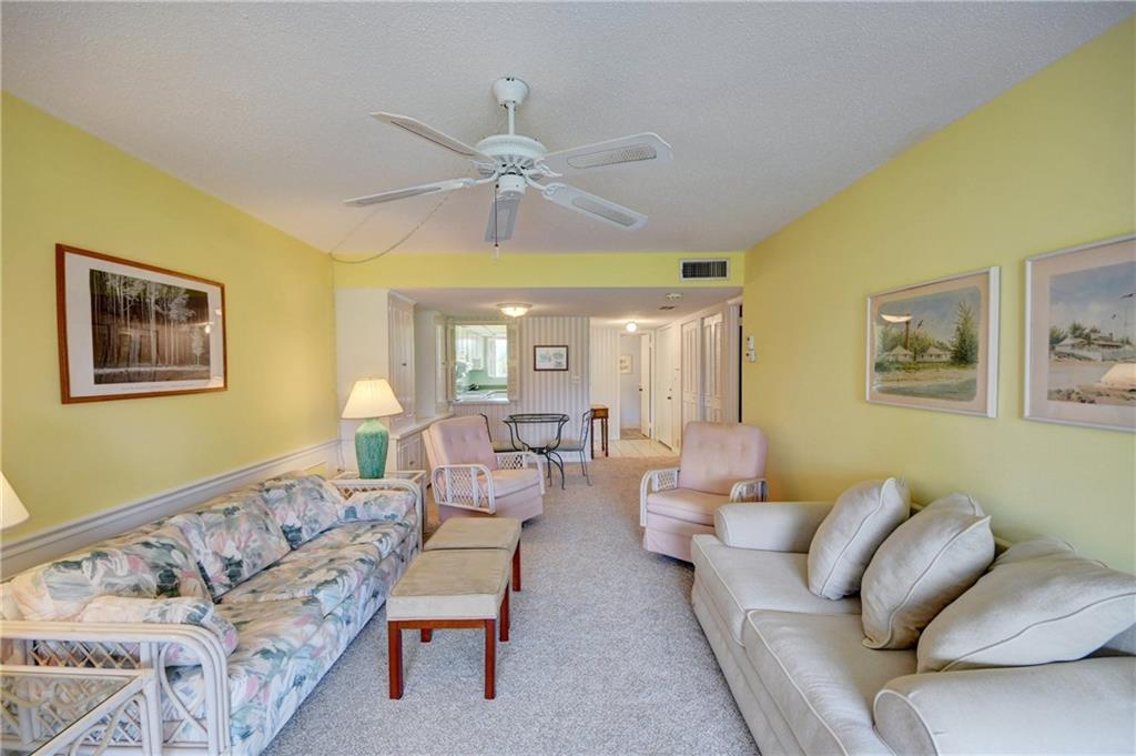 5111 Southeast Miles Grant Road, Unit 104 Stuart, FL 34997 - Photo 8 of 36 a living room with furniture and a large window