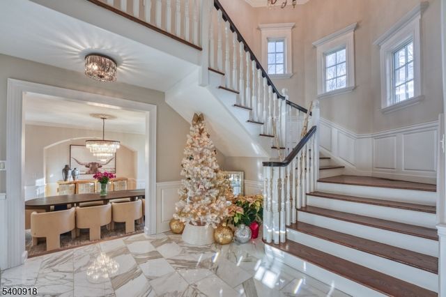 a living room with furniture and a chandelier