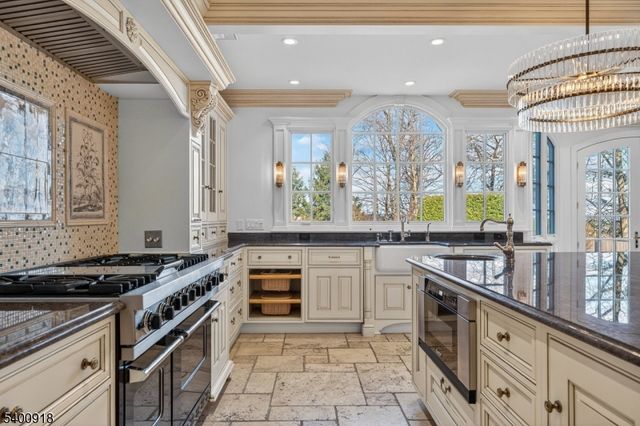 a living room with furniture and floor to ceiling windows