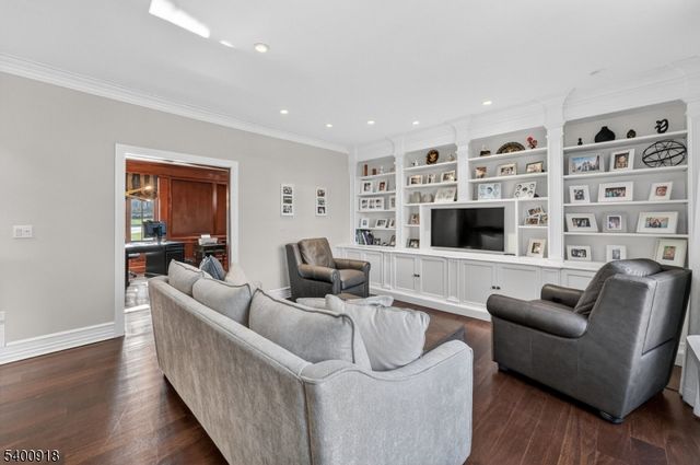 a bathroom with a granite countertop sink a large mirror and a bathtub next to a window