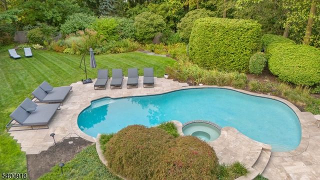 an aerial view of a house with garden space and street view