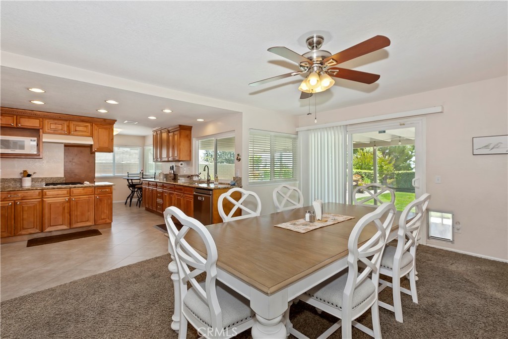 8527 Hillside Road Rancho Cucamonga, CA 91701 - Photo 13 of 50 a dining room with furniture a window and a kitchen view