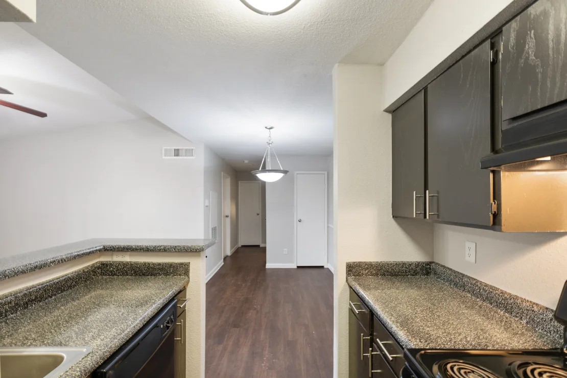 2800 South Ashford Road, Unit 2206 Houston, TX 77082 - Photo 26 of 35 a kitchen with granite countertop a sink a stove oven and counter space