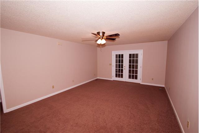 291 Rivendell Road Woodbury, TN 37190 - Photo 3 of 12 Spacious living area with french doors leading to the deck overlooking wooded area behind home.