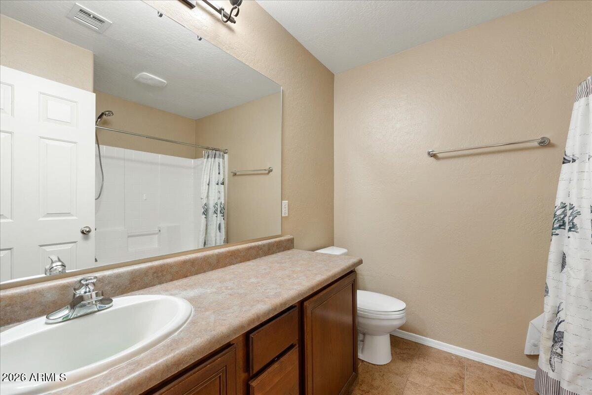 813 Alfonse Road Clarkdale, AZ 86324 - Photo 14 of 41 a bathroom with a granite countertop sink a toilet and a mirror